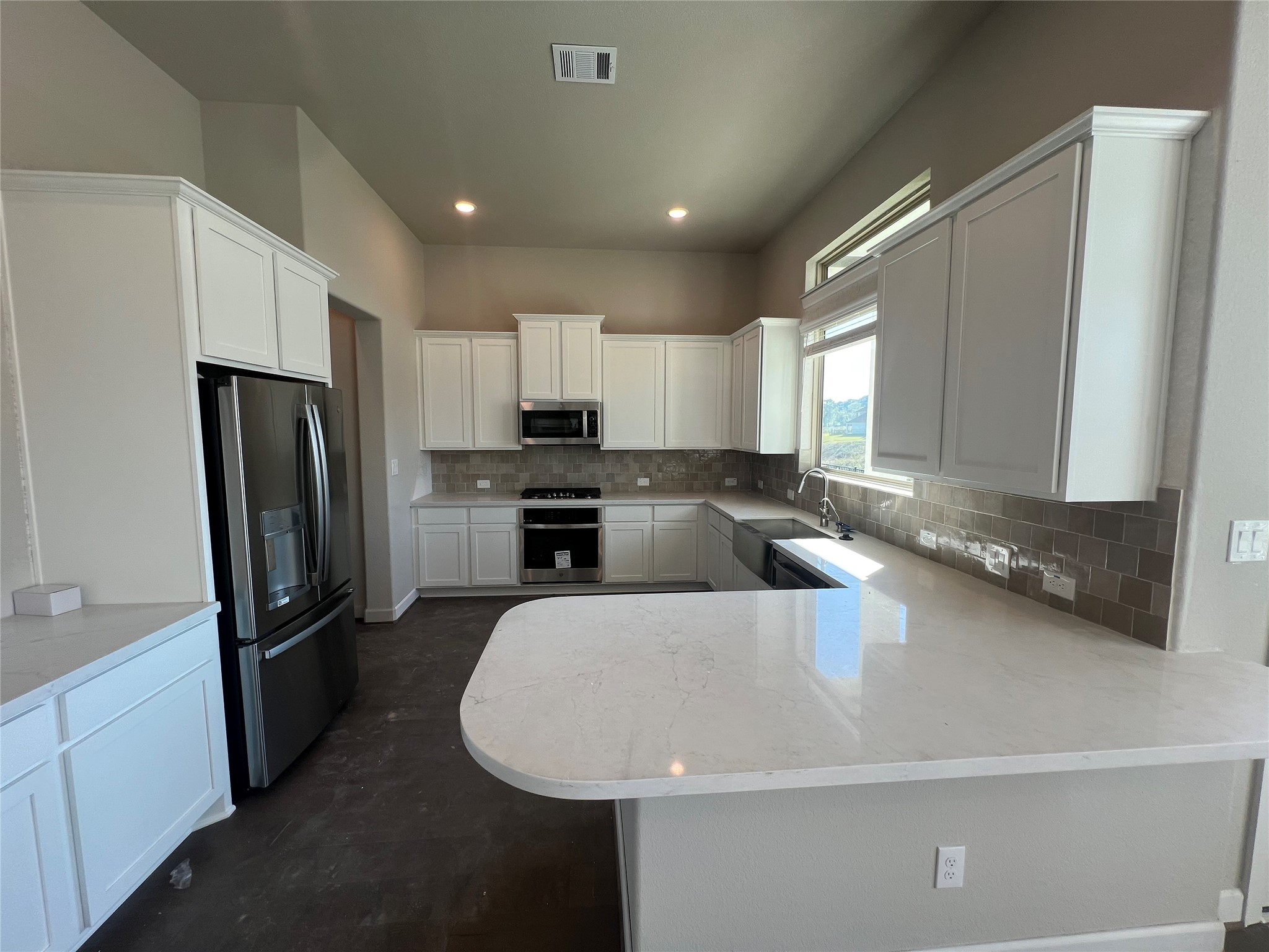 136 Peninsula Point Drive Montgomery, TX 77356 - Photo 6 of 36 a large kitchen with a large window and stainless steel appliances