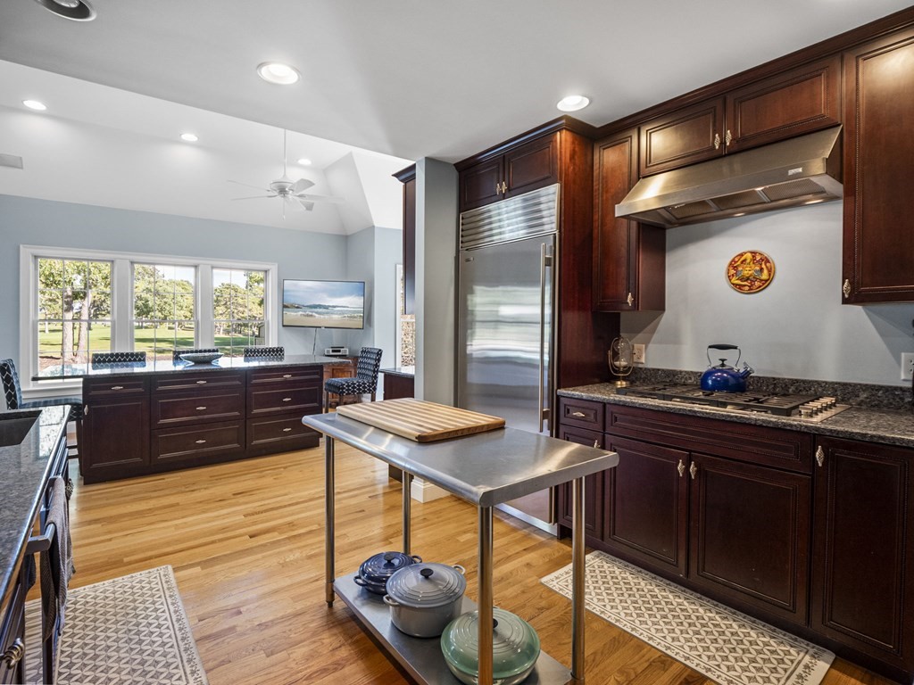 90 Howes Path Dennis, MA 02638 - Photo 11 of 42 a kitchen with a sink and wooden cabinets