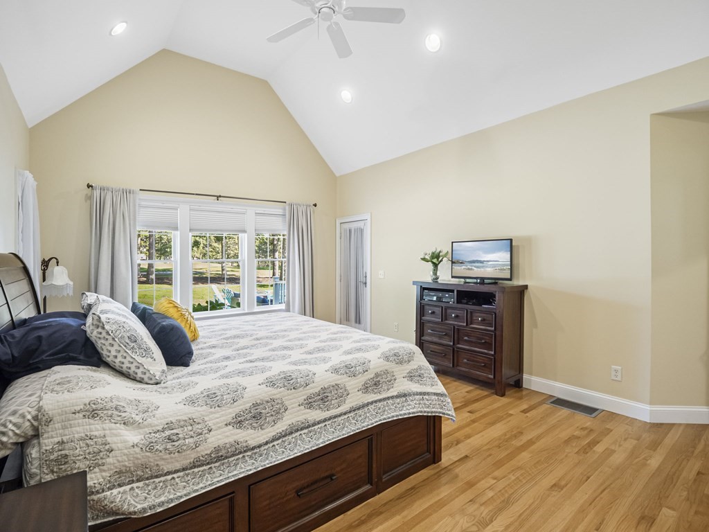 90 Howes Path Dennis, MA 02638 - Photo 16 of 42 a bedroom with a bed and a dresser with wooden floor