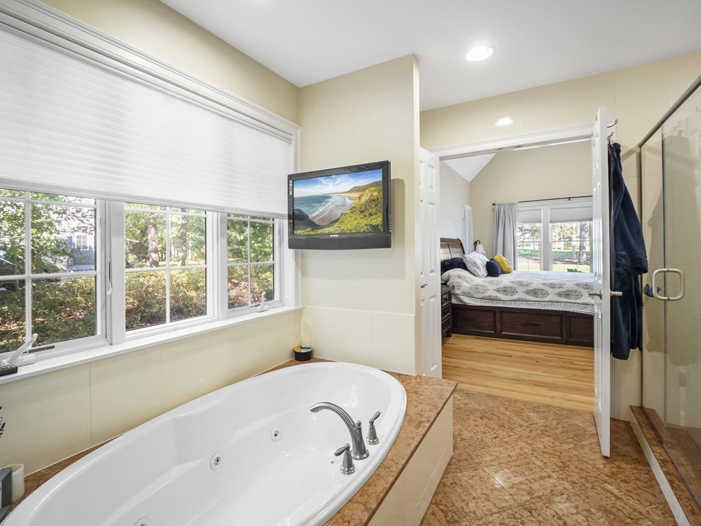 90 Howes Path Dennis, MA 02638 - Photo 19 of 42 a bathroom with a tub a sink and a large window