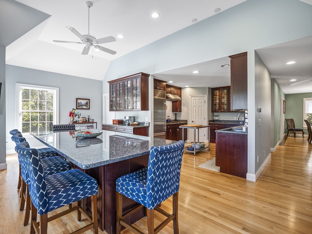 90 Howes Path Dennis, MA 02638 - Photo 7 of 42 a dining room with furniture a rug a fireplace and a chandelier