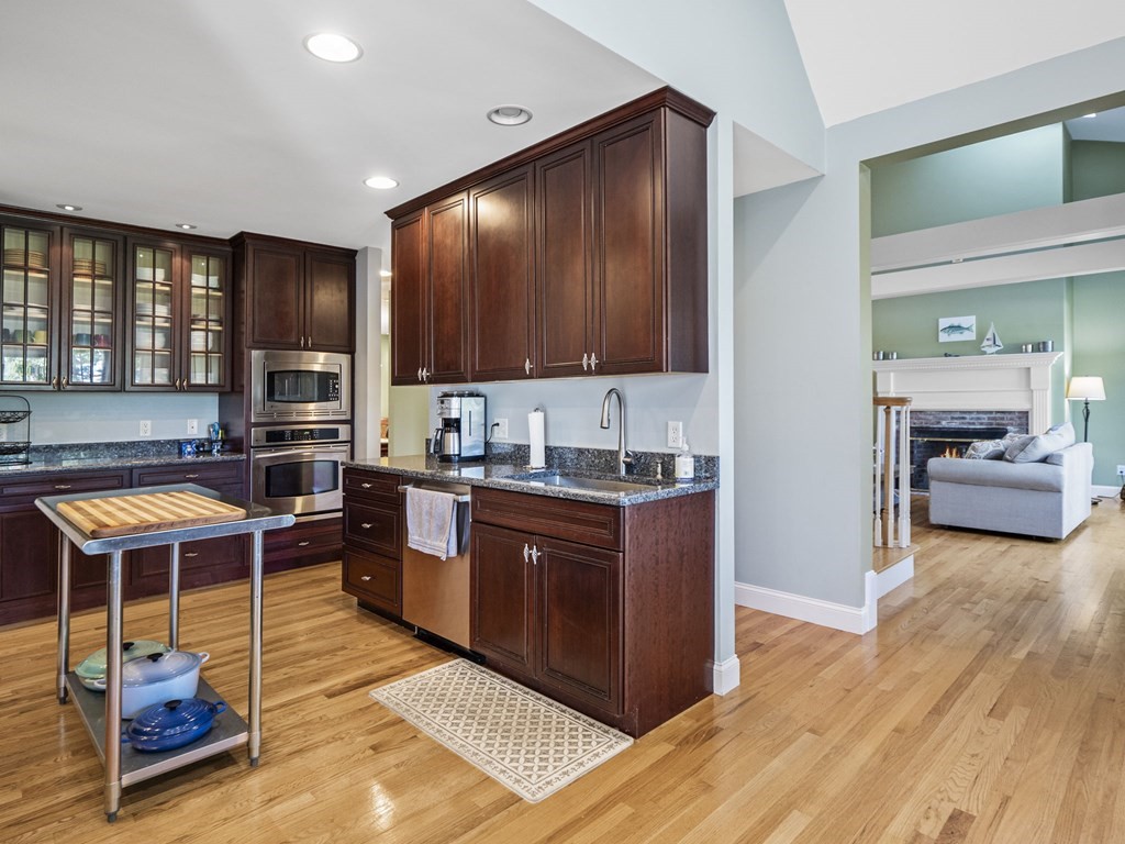 90 Howes Path Dennis, MA 02638 - Photo 9 of 42 a kitchen with granite countertop a sink cabinets and wooden floor