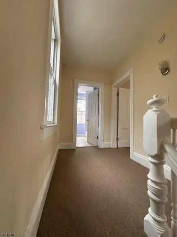 a view of entryway and hall with a window