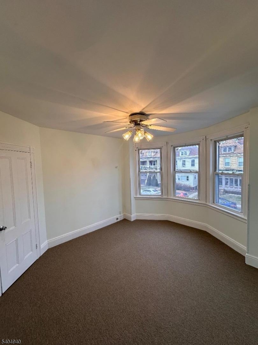 956 Lafayette Street Elizabeth, NJ 07201 - Photo 13 of 20 a view of an empty room with a window