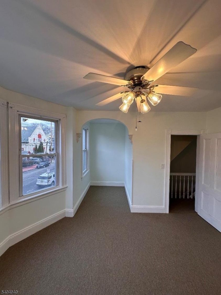 956 Lafayette Street Elizabeth, NJ 07201 - Photo 14 of 20 an empty room with windows and fan