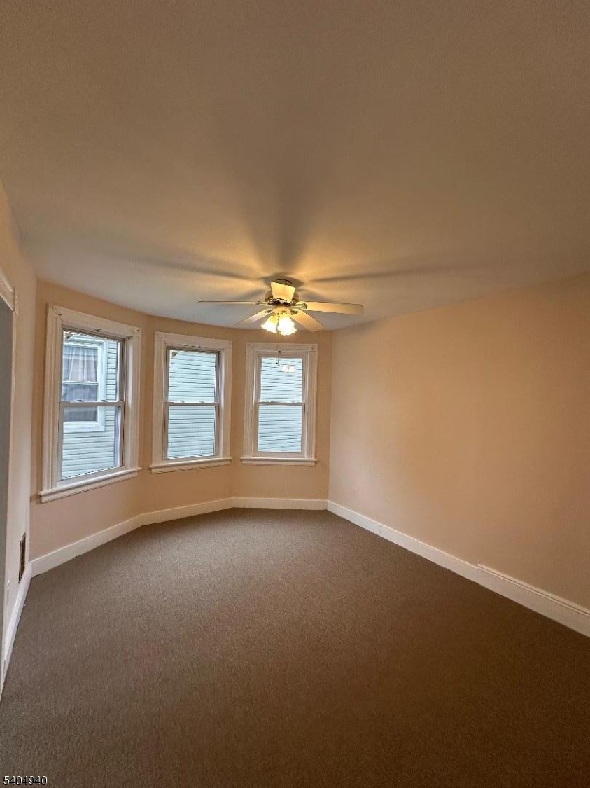 956 Lafayette Street Elizabeth, NJ 07201 - Photo 15 of 20 an empty room with a empty space and windows