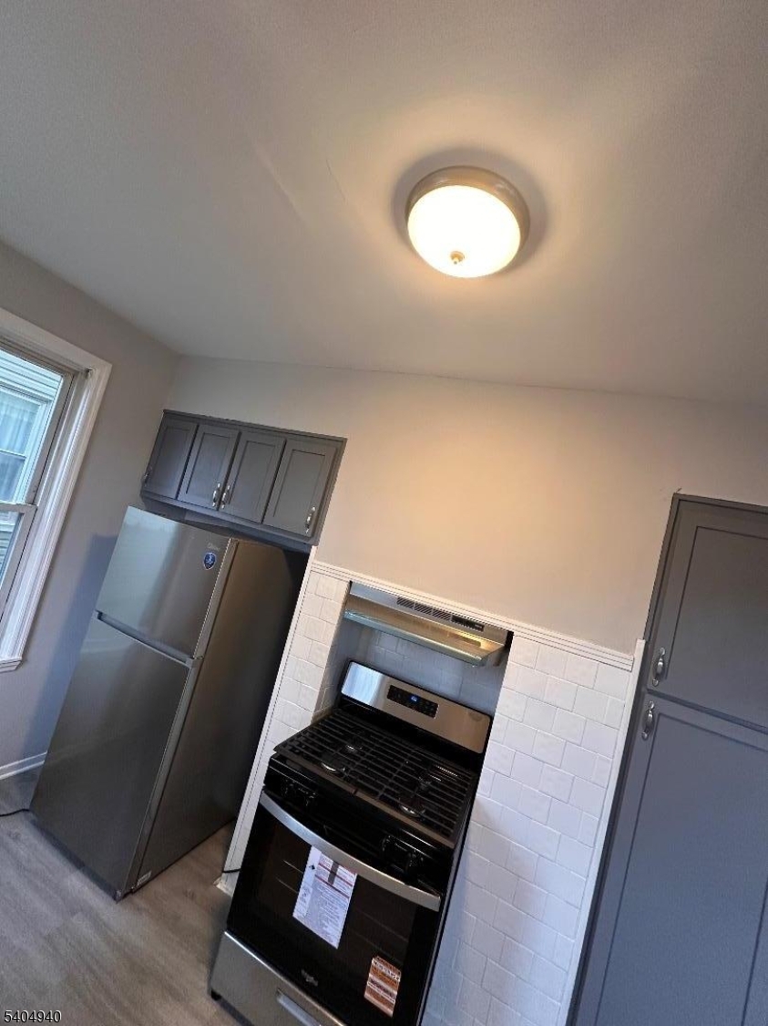 956 Lafayette Street Elizabeth, NJ 07201 - Photo 8 of 20 a view of an empty room and wooden floor