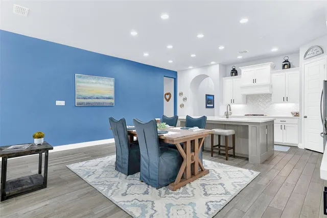 a living room with dining room and wooden floor