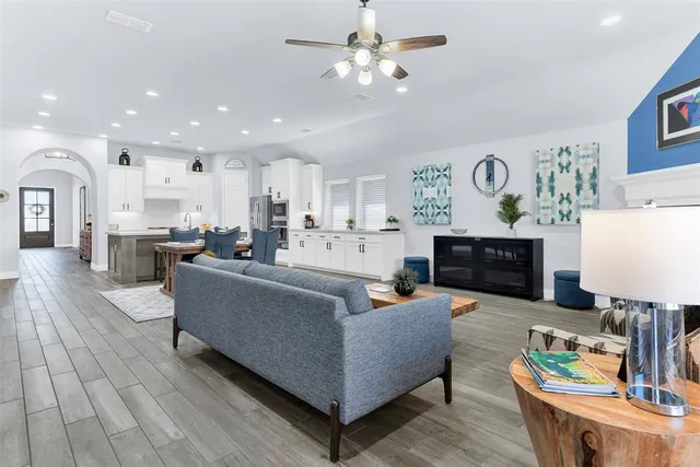 a living room with fireplace furniture and a wooden floor