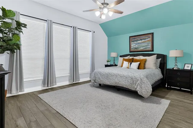 a bedroom with a large bed and a chandelier