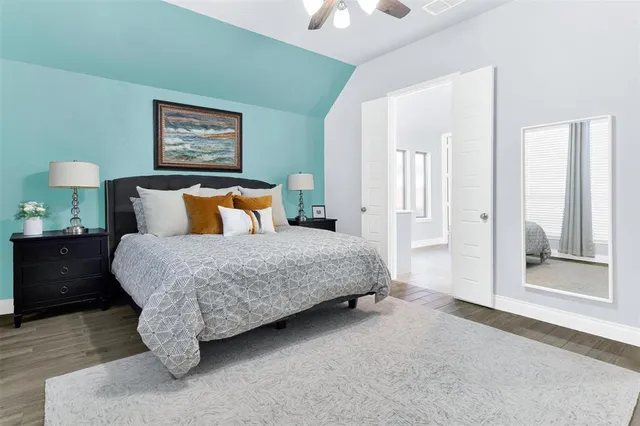 a bedroom with a bed and a lamp