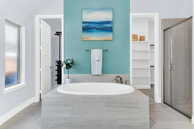 a bathroom with a tub and shower