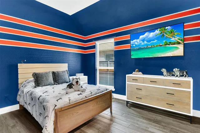 a bedroom with a bed and a window