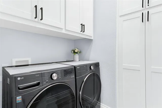 a view of a patio with table and chairs potted plants with wooden floor and fence