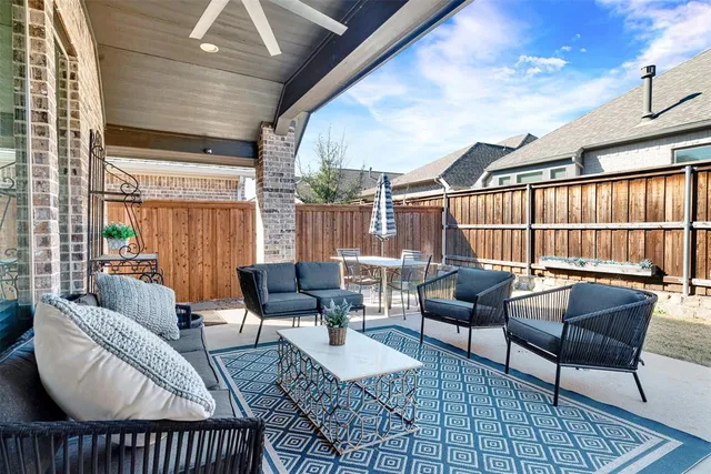 a view of a house with backyard porch and sitting area