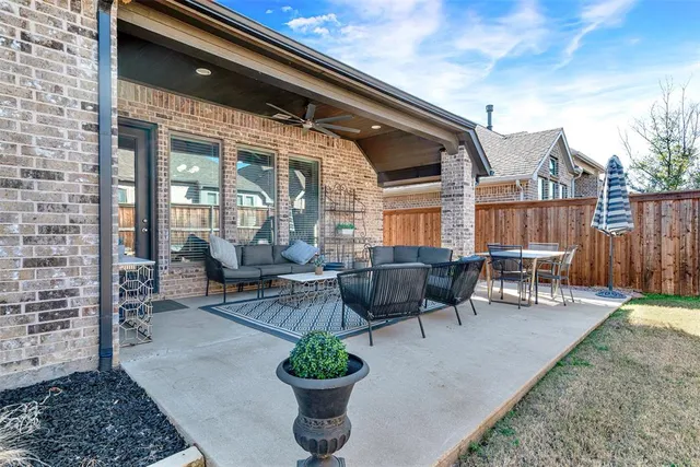 a view of a patio with table and chairs potted plants with wooden floor