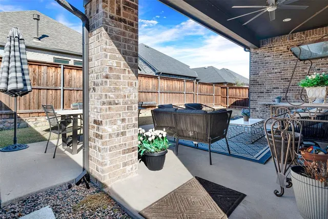 a backyard of a house with yard and outdoor seating