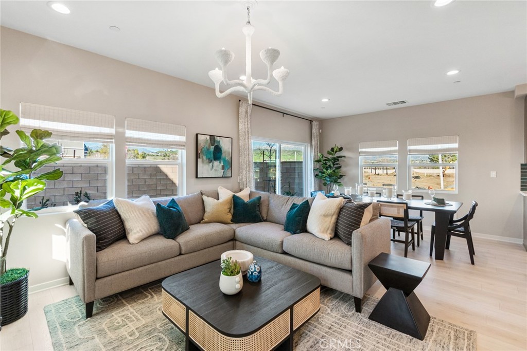31975 Monet Place Yucaipa, CA 92399 - Photo 3 of 32 a living room with furniture potted plant and a large window