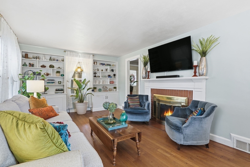32 Pennsylvania Avenue Springfield, MA 01118 - Photo 11 of 41 a living room with furniture a flat screen tv and a fireplace