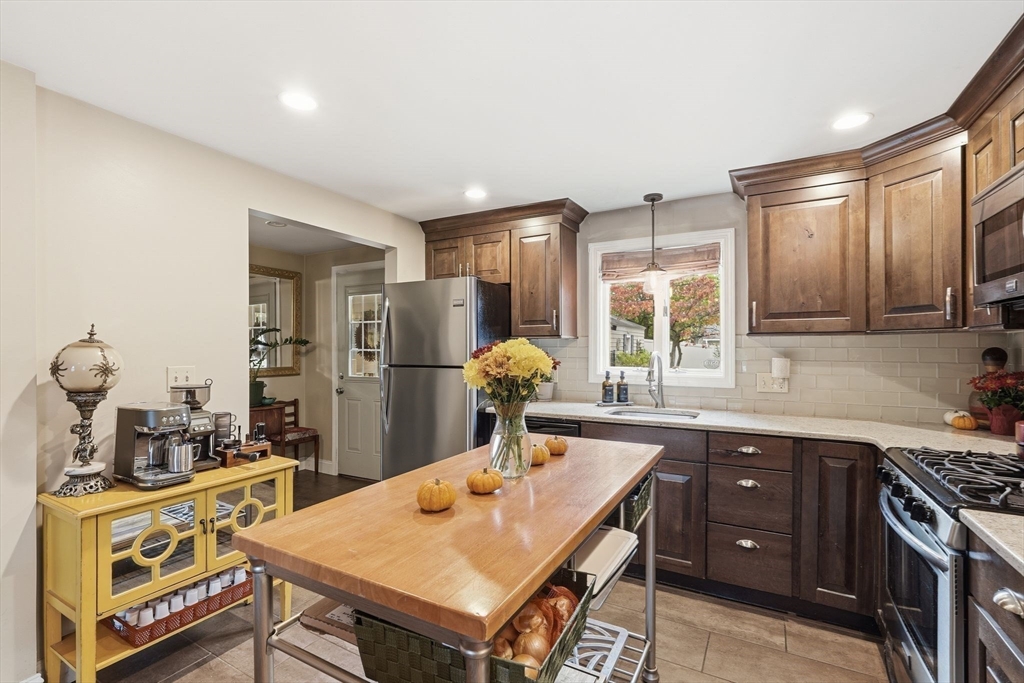 32 Pennsylvania Avenue Springfield, MA 01118 - Photo 15 of 41 a kitchen with stainless steel appliances granite countertop a sink stove and refrigerator