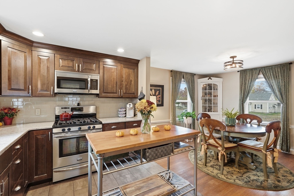 32 Pennsylvania Avenue Springfield, MA 01118 - Photo 16 of 41 a kitchen with a stove a sink and a microwave