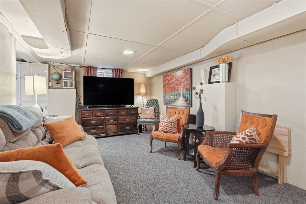 32 Pennsylvania Avenue Springfield, MA 01118 - Photo 26 of 41 a living room with furniture and a flat screen tv