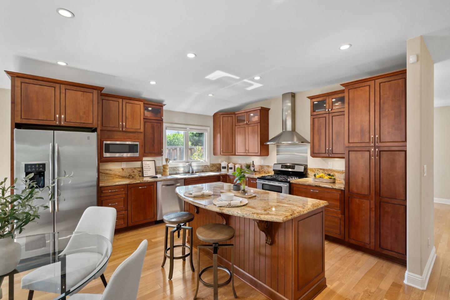 1030 Ashley Place Mountain View, CA 94040 - Photo 15 of 32 a kitchen with stainless steel appliances granite countertop a table chairs and a refrigerator