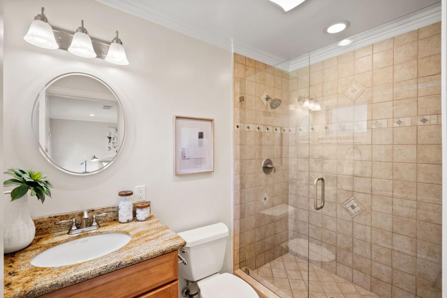 1030 Ashley Place Mountain View, CA 94040 - Photo 25 of 32 a bathroom with a granite countertop sink toilet a mirror a shower and vanity