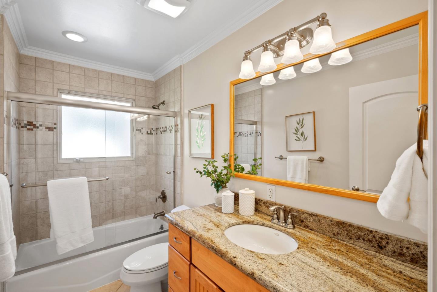 1030 Ashley Place Mountain View, CA 94040 - Photo 26 of 32 a bathroom with a granite countertop sink a toilet a mirror a vanity and shower