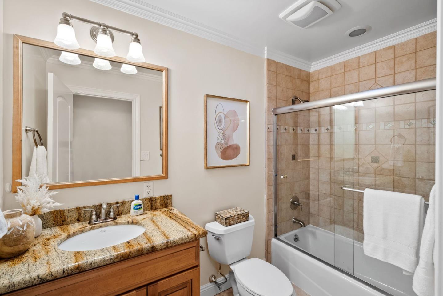 1030 Ashley Place Mountain View, CA 94040 - Photo 27 of 32 a bathroom with a granite countertop sink toilet a mirror a bathtub and shower