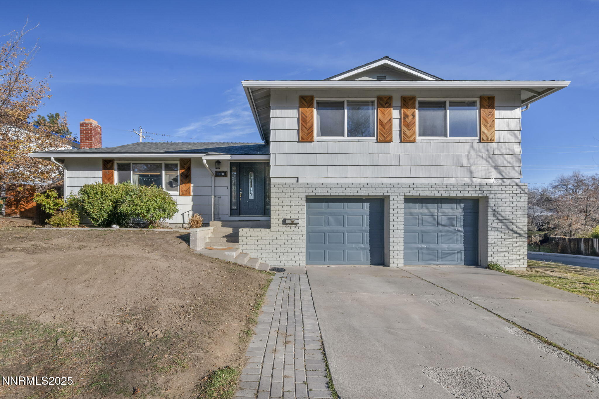 a front view of a house with yard and green space