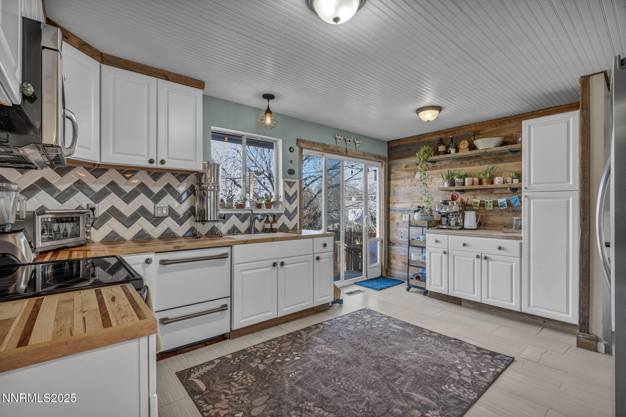1100 Mission Circle Reno, NV 89503 - Photo 15 of 61 a kitchen with white cabinets and window