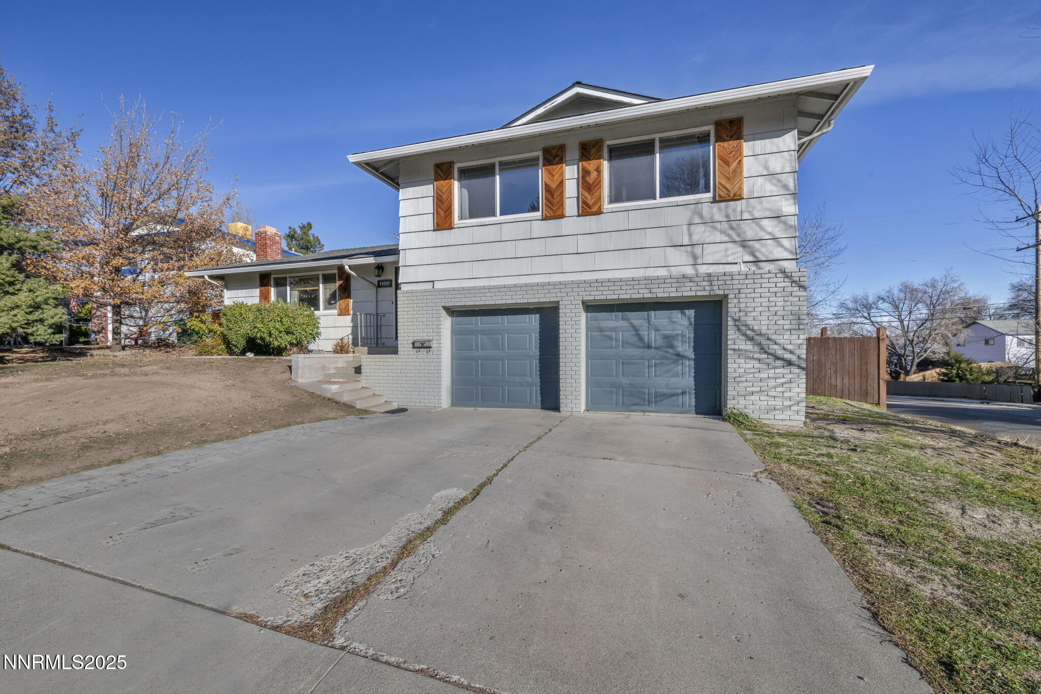 1100 Mission Circle Reno, NV 89503 - Photo 2 of 61 a front view of a house with a yard and garage