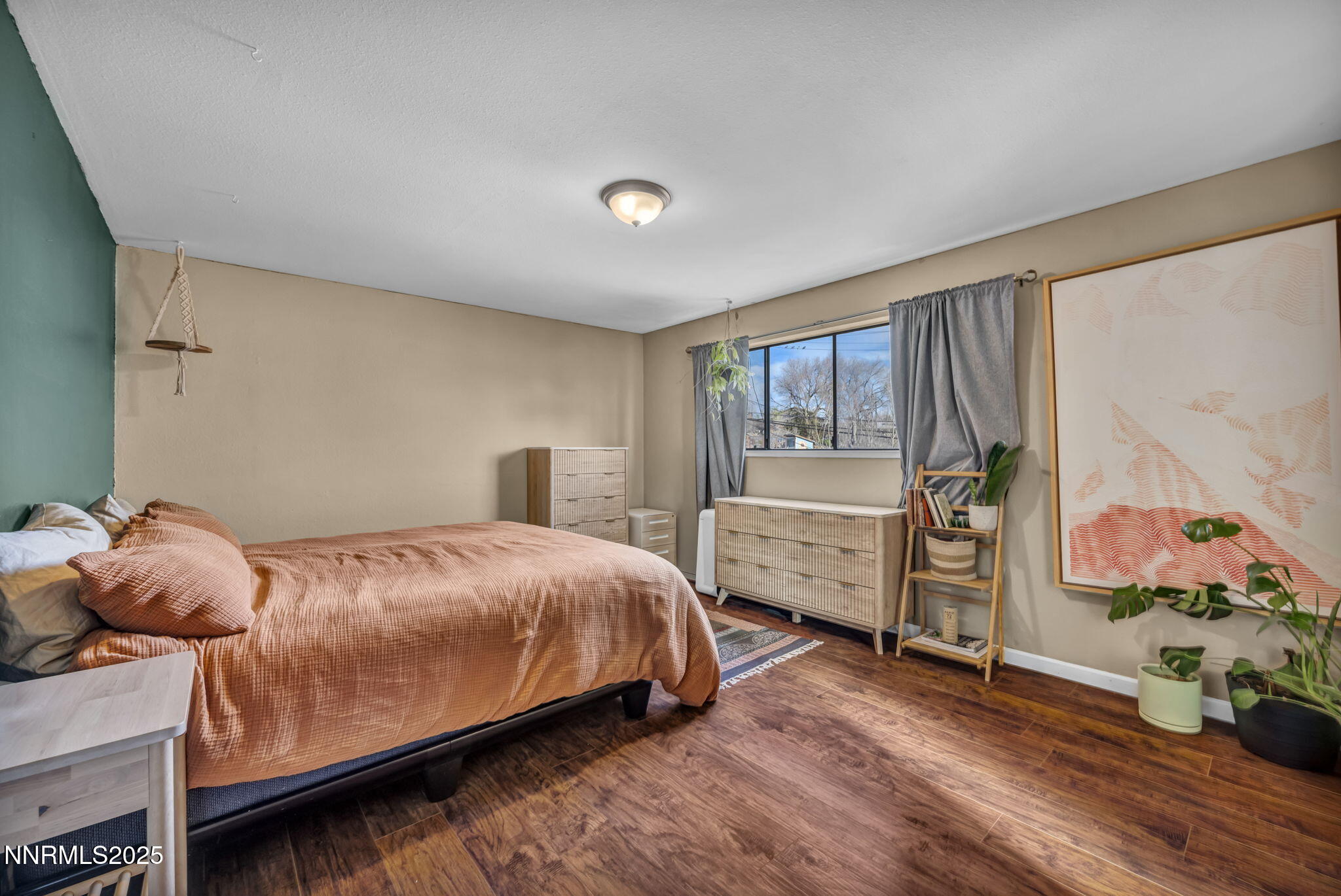 1100 Mission Circle Reno, NV 89503 - Photo 26 of 61 a bedroom with a bed and wooden floor