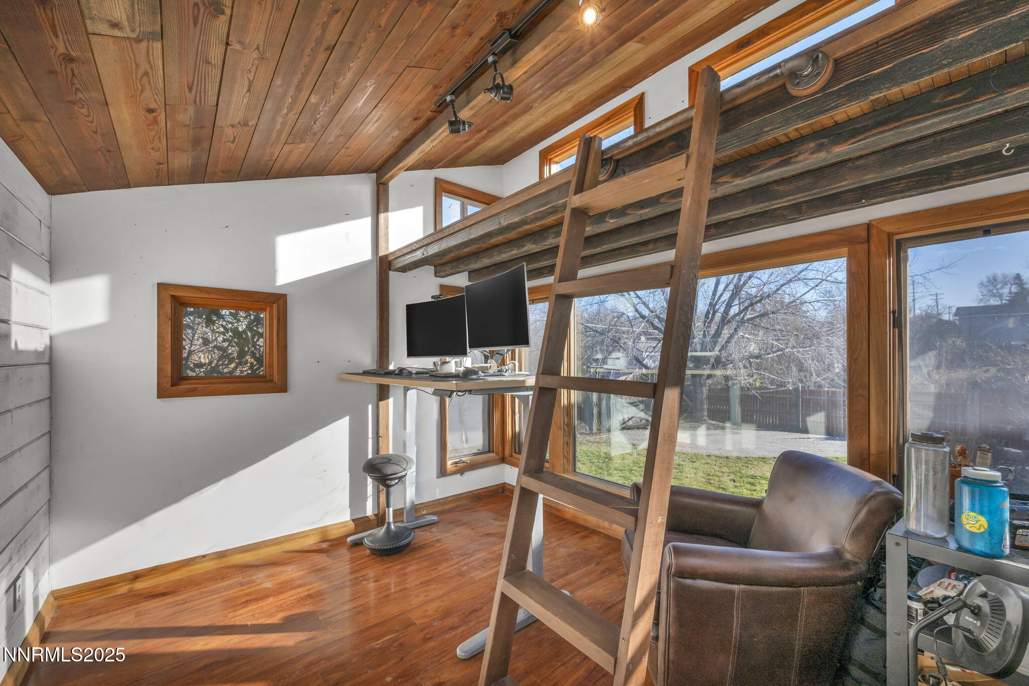 1100 Mission Circle Reno, NV 89503 - Photo 38 of 61 a living room with furniture a flat screen tv and floor to ceiling window