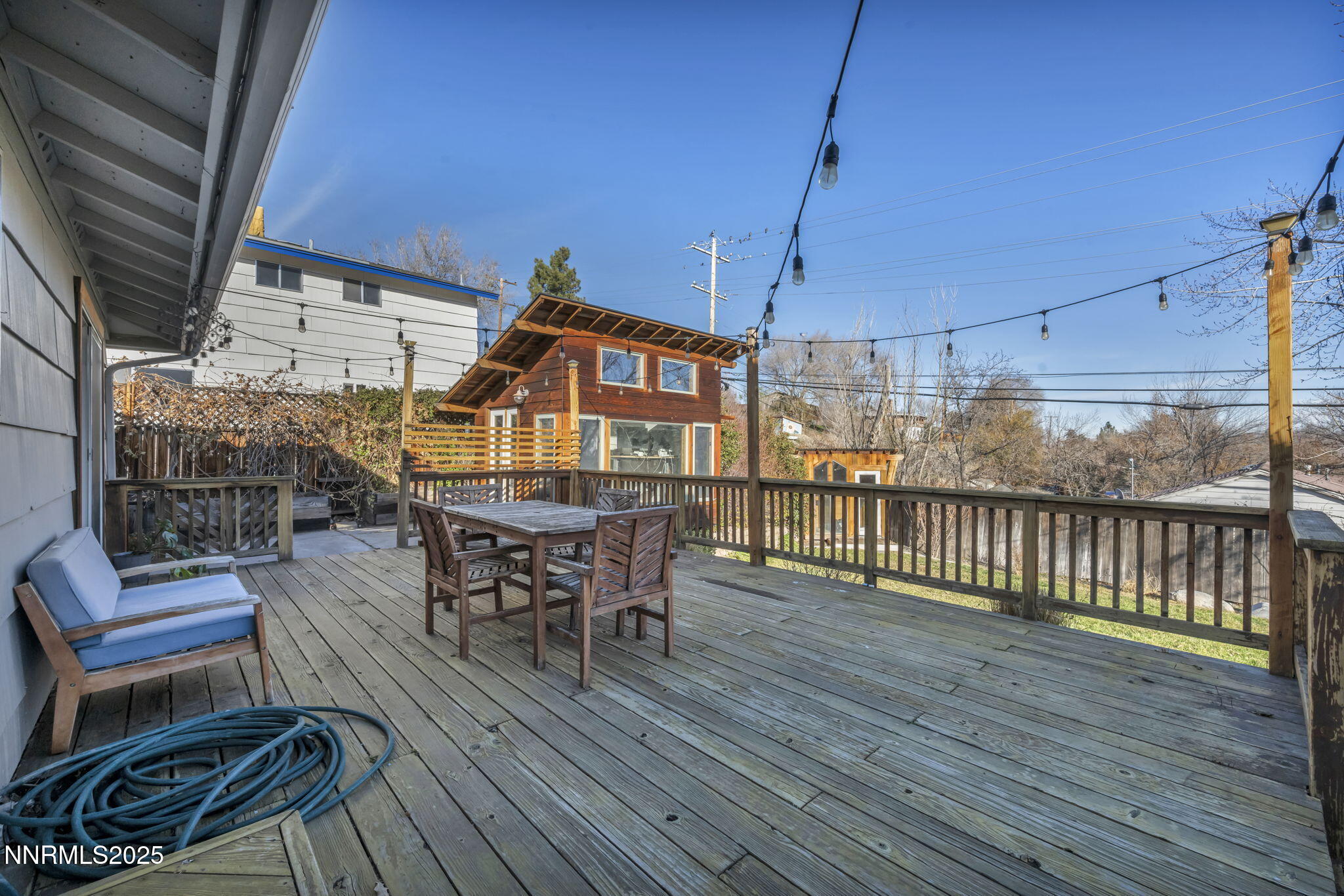 1100 Mission Circle Reno, NV 89503 - Photo 47 of 61 a view of a roof deck with table and chairs with wooden floor