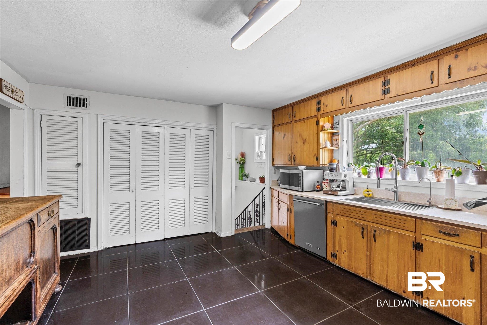 4213 Shan Drive East Mobile, AL 36693 - Photo 10 of 35 Kitchen featuring abundant wood cabinetry, an undermount sink, and a large window