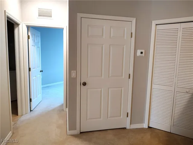 a view of a hallway with closet area