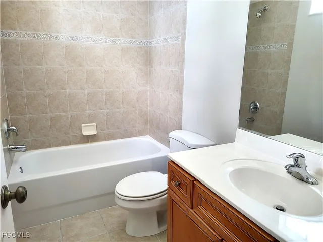 a bathroom with a sink a toilet and bathtub
