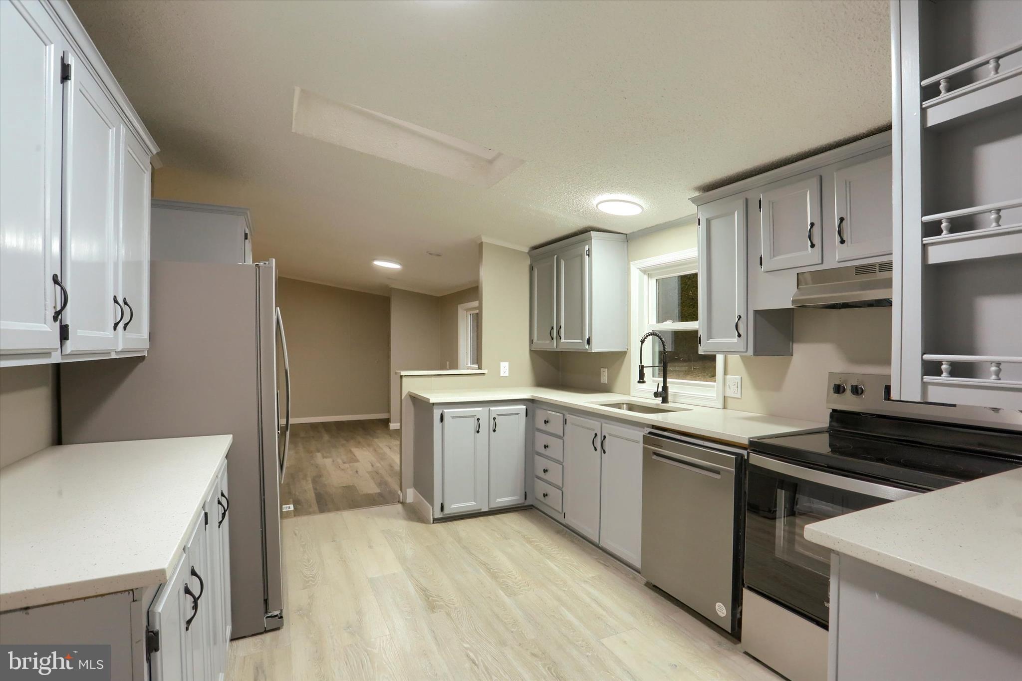 1311 Woodbine Road Airville, PA 17302 - Photo 11 of 29 a kitchen with stainless steel appliances sink stove microwave and cabinets