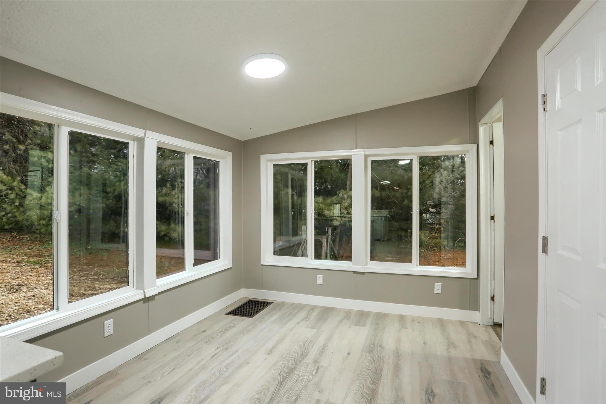 1311 Woodbine Road Airville, PA 17302 - Photo 12 of 29 a view of an empty room with a floor to ceiling window and an entryway