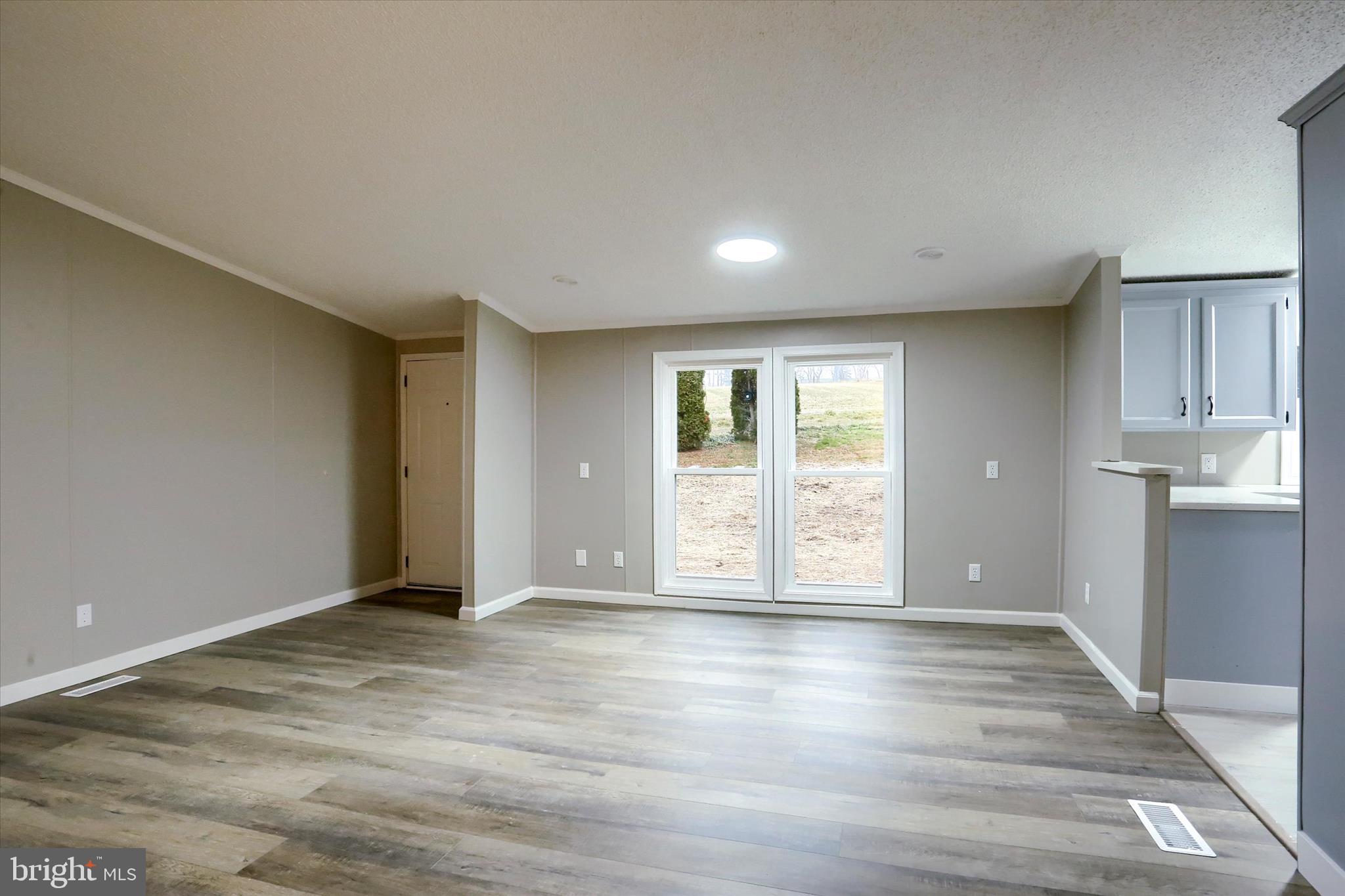 1311 Woodbine Road Airville, PA 17302 - Photo 8 of 29 a view of an empty room with wooden floor and a window