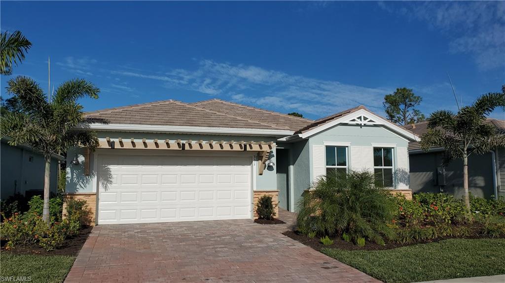 331 Tamarindo Lane Naples, FL 34114 - Photo 1 of 24 a front view of a house with a garden