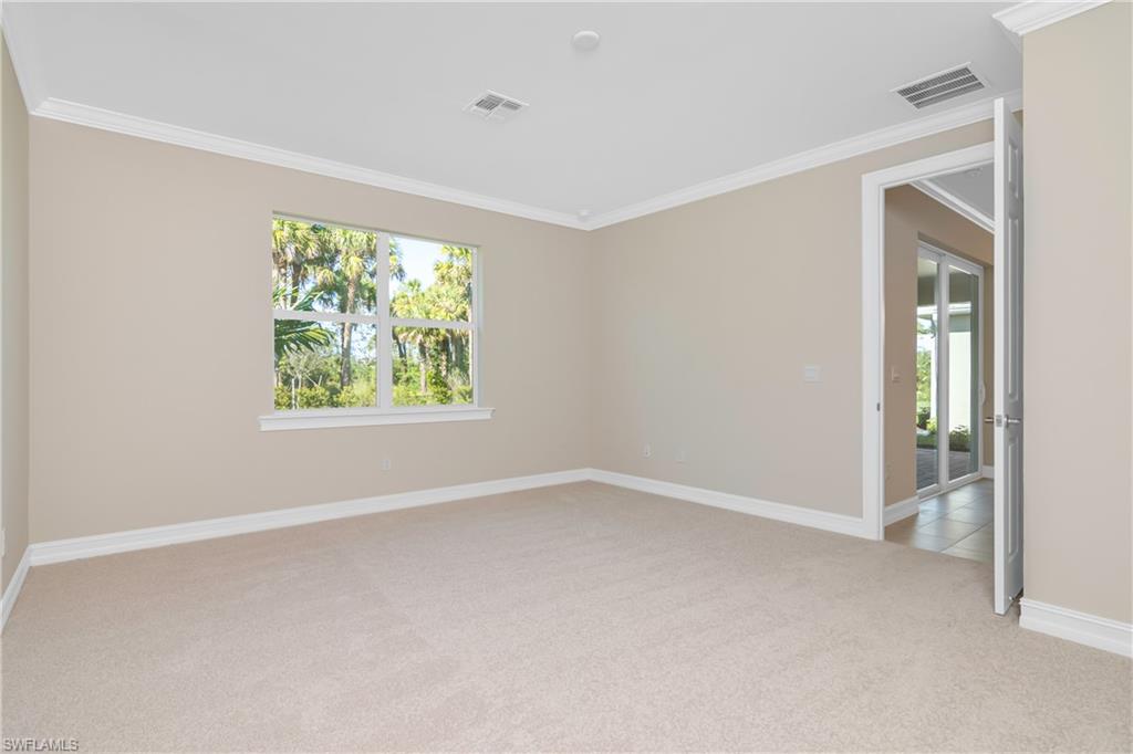 331 Tamarindo Lane Naples, FL 34114 - Photo 14 of 24 an empty room with windows