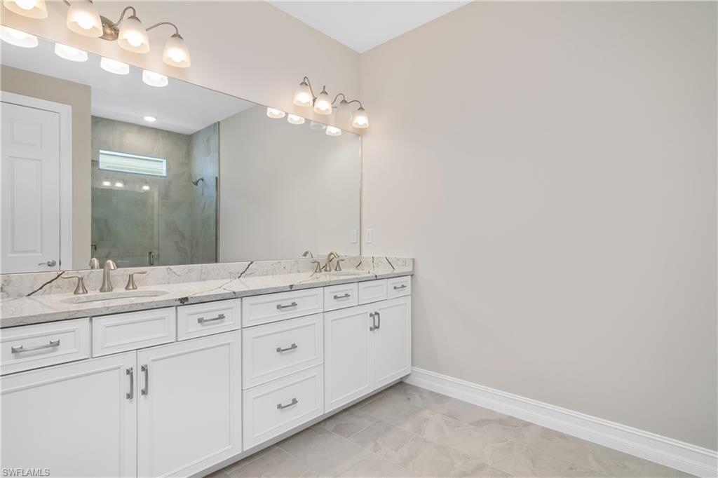 331 Tamarindo Lane Naples, FL 34114 - Photo 15 of 24 a bathroom with a double vanity sink and a mirror