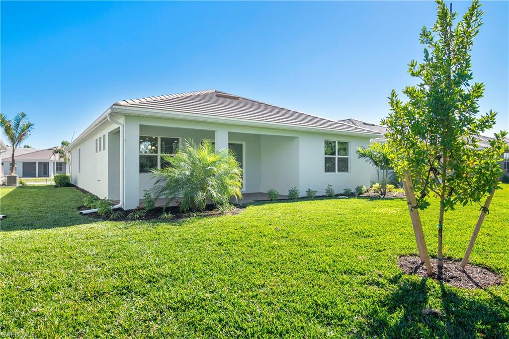 331 Tamarindo Lane Naples, FL 34114 - Photo 24 of 24 a front view of a house with garden