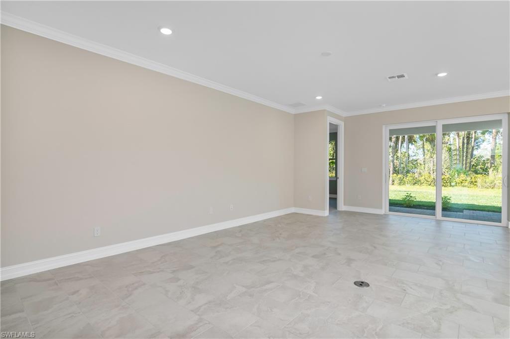 331 Tamarindo Lane Naples, FL 34114 - Photo 3 of 24 wooden floor in an empty room with a window