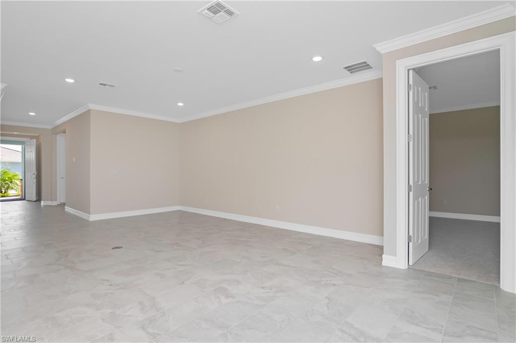 331 Tamarindo Lane Naples, FL 34114 - Photo 4 of 24 an empty room with windows and entrance