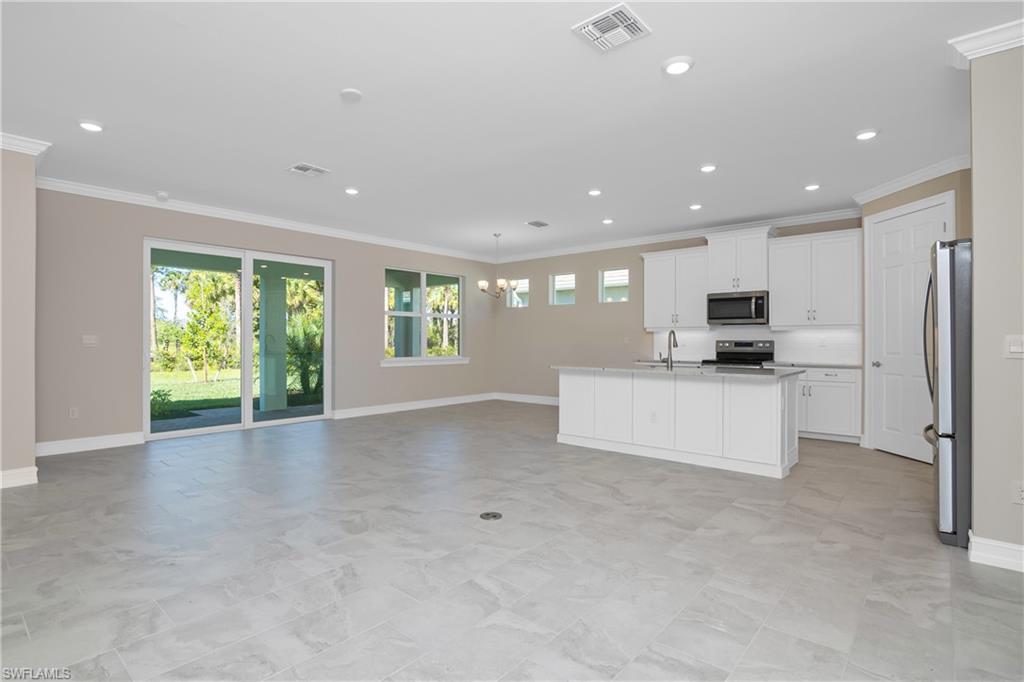 331 Tamarindo Lane Naples, FL 34114 - Photo 6 of 24 a view of kitchen with stainless steel appliances refrigerator oven microwave and stove