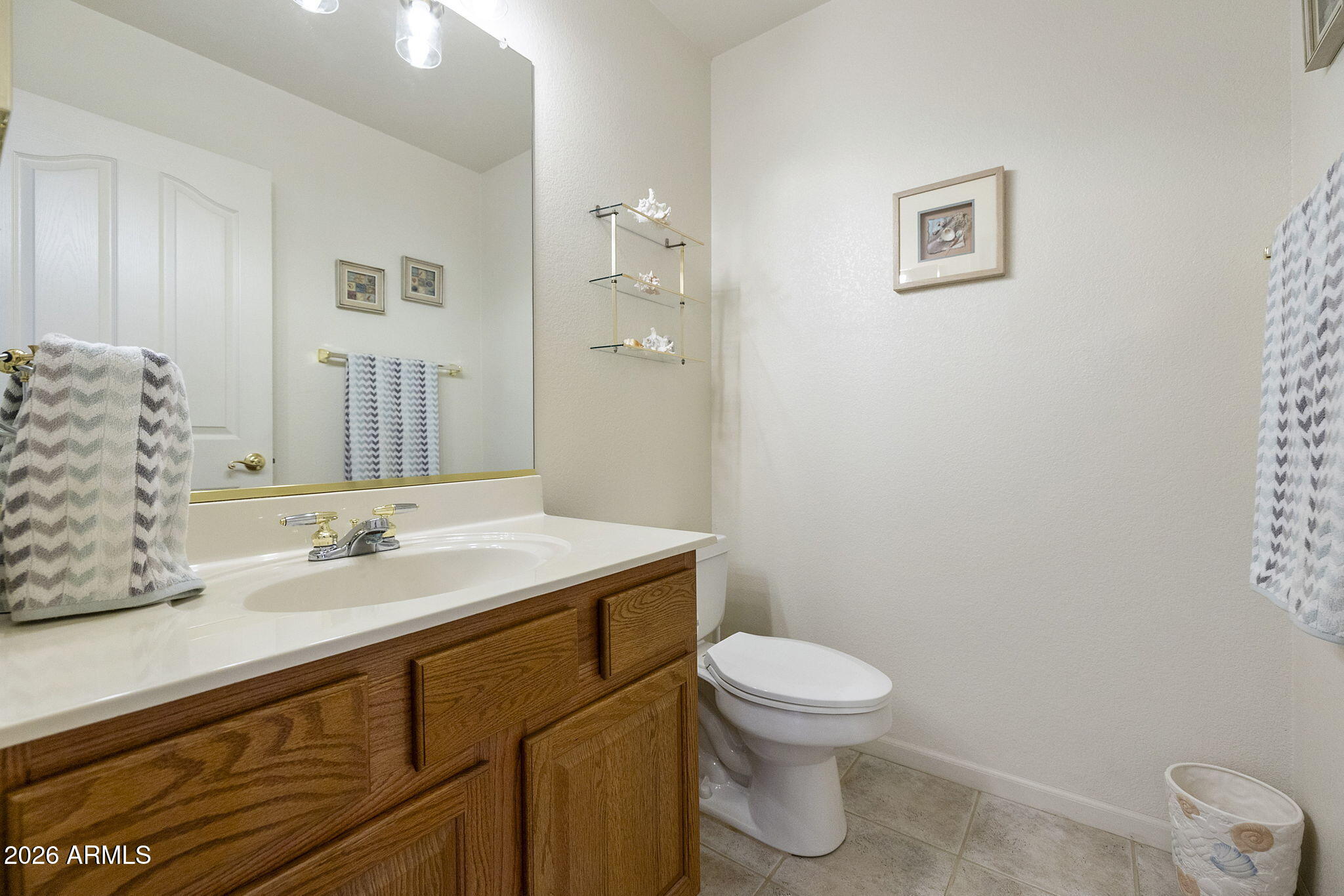 12435 West Monte Vista Road Avondale, AZ 85392 - Photo 17 of 69 a bathroom with a sink a toilet and mirror